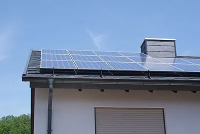Photovoltaikmodule auf einem Flachdach mit Kaminkopf